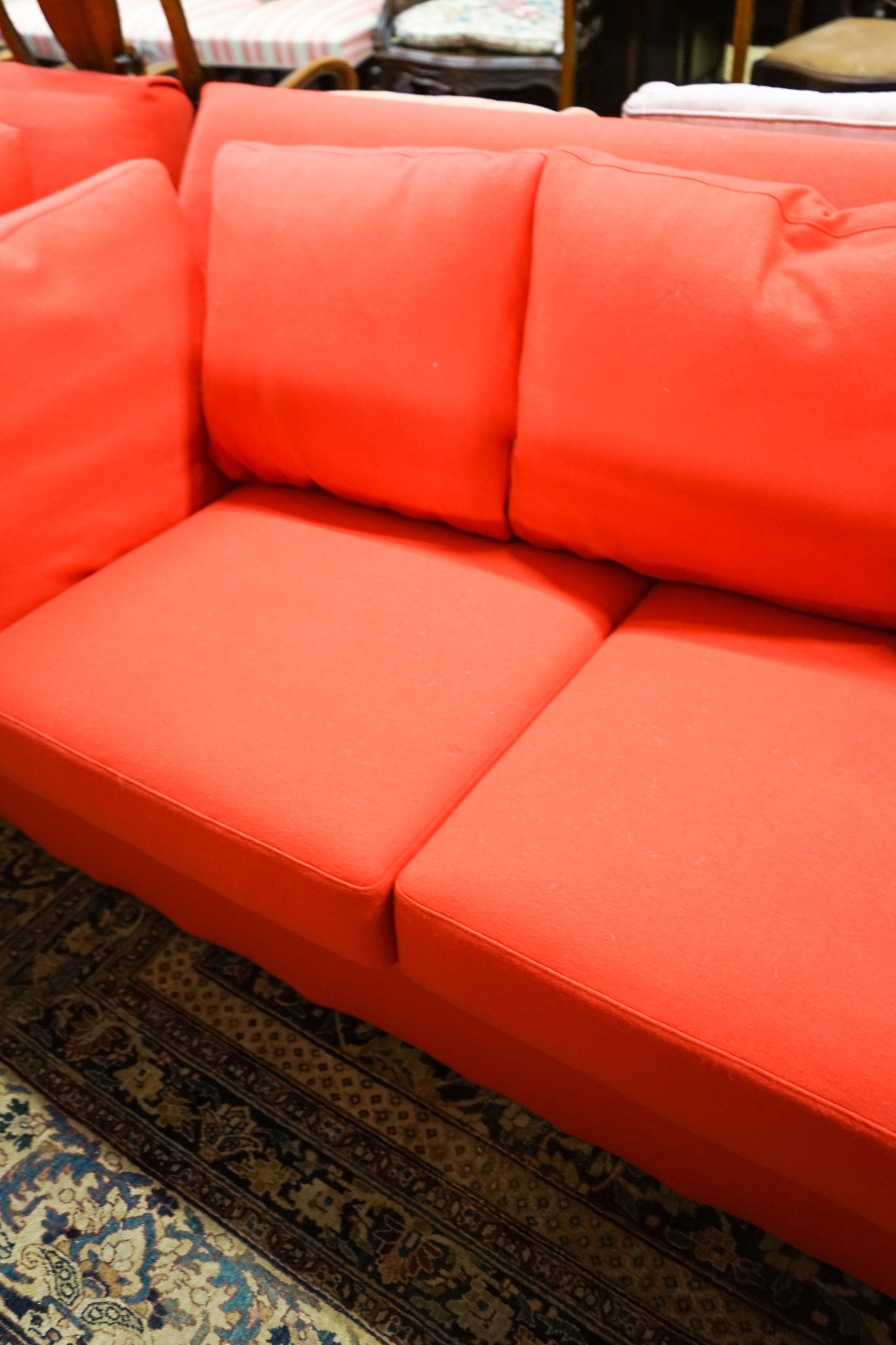 A contemporary Moroso three seater and two seater sofa upholstered in red fabric, the larger length 250cm, depth 100cm, height 79cm